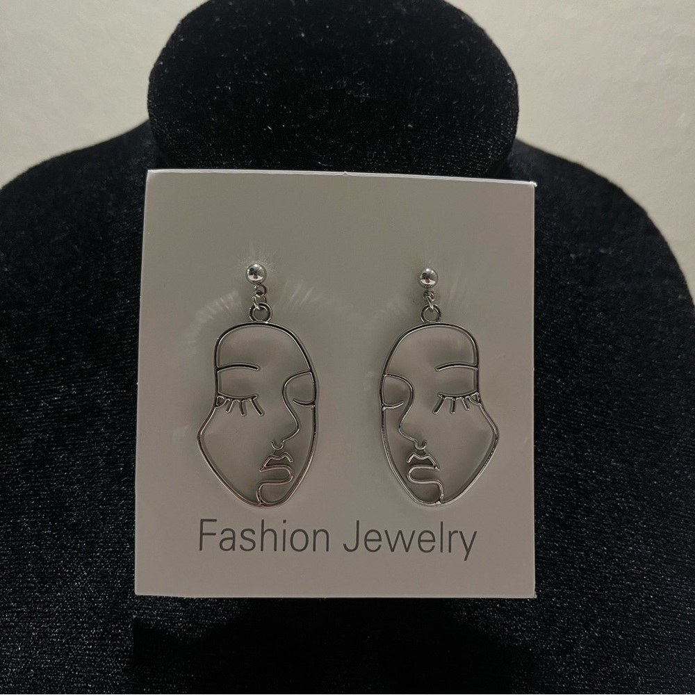 Silver face earrings
